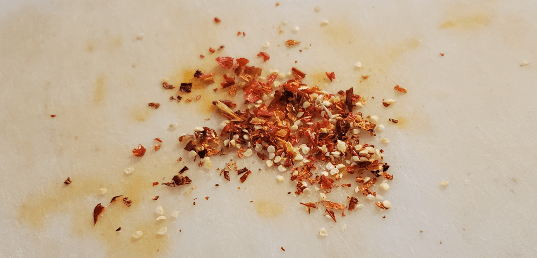 Hot chili pepper flakes on a cutting board